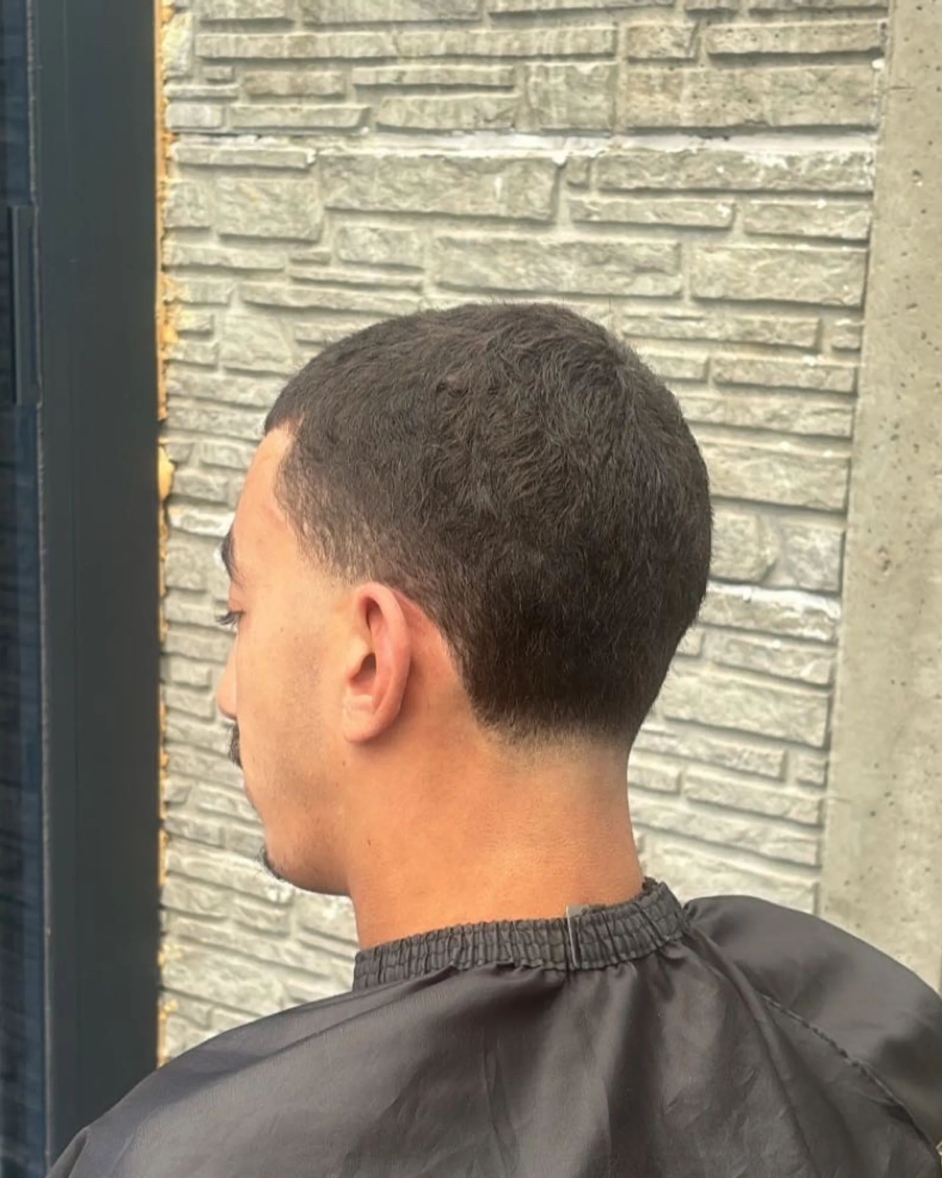 After: cut short, with a sharp line at the temple and a cleanly finished neck.