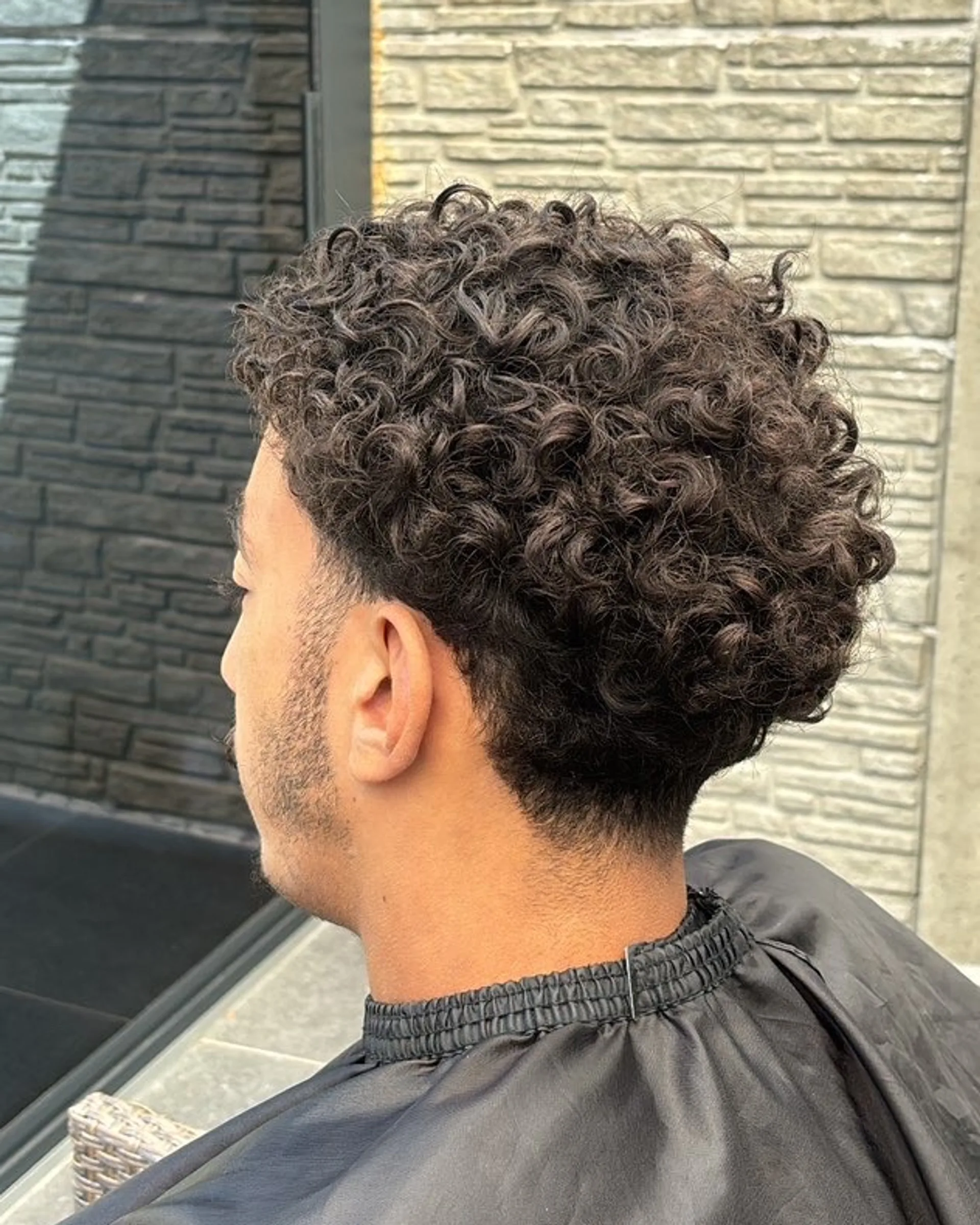 Before: grown-out, full curls running down into the neck.